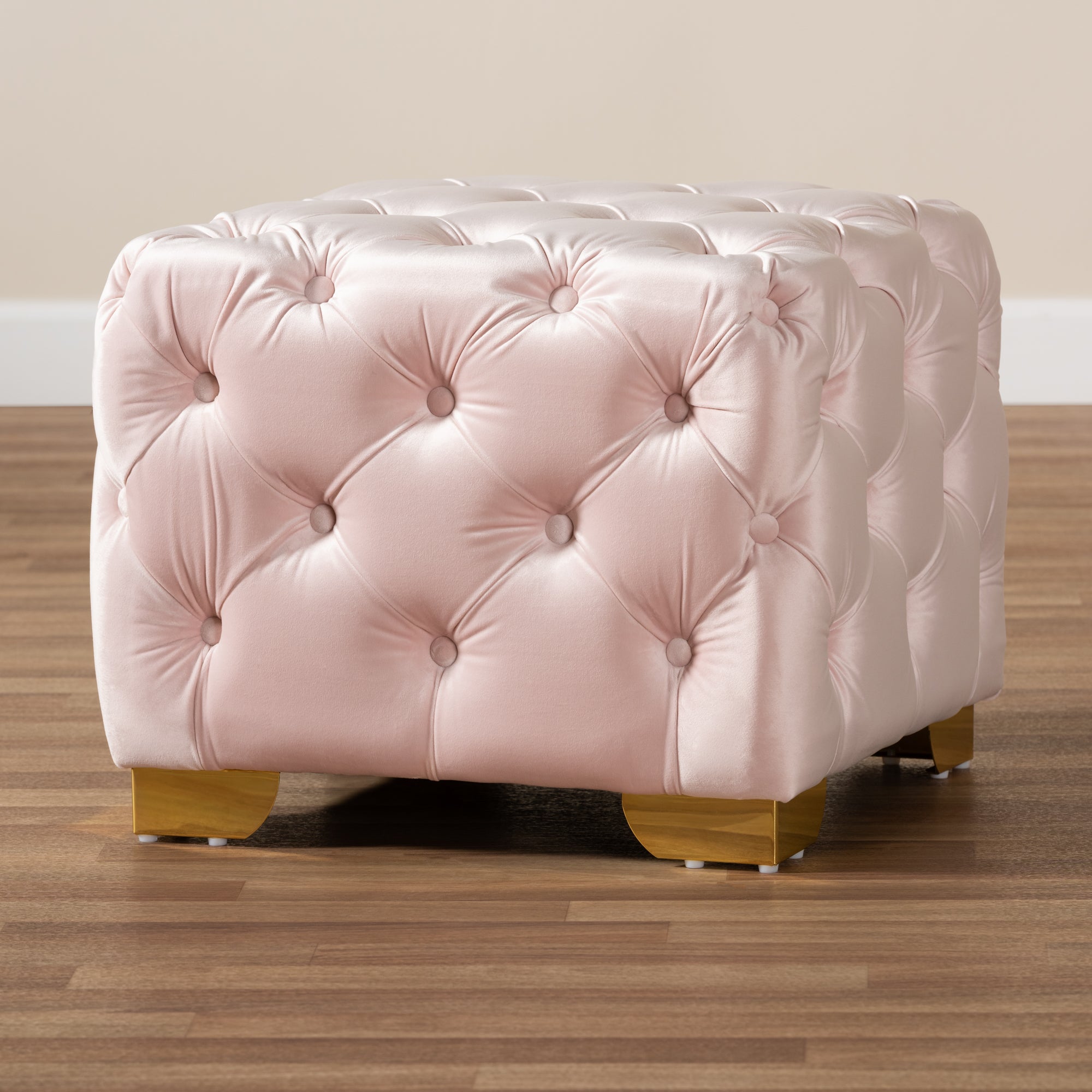 Avara Light Pink Velvet Fabric Upholstered Gold Finished Button Tufted Ottoman
